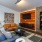 wall mounted tv and couches in bright clubhouse